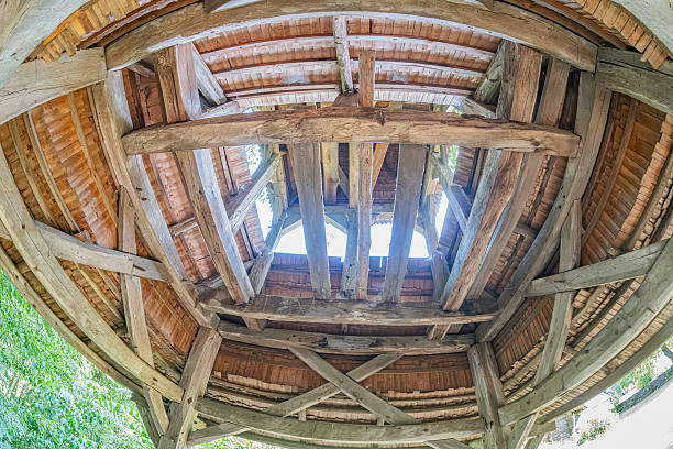 istock Rustic wooden building with a star-patterned ceiling, missing pieces, natural light, earth floor, debris, muted colors, early morninglate afternoon lighting, ancient Central European village 2230259339