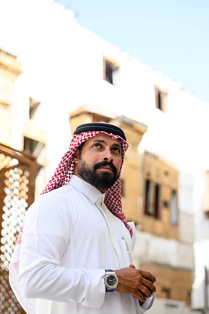 istock Thoughtful Middle Eastern man looking away while standing in historic alleyway 2230268895