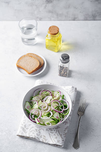Cucumber red onion sesame seeds salad in a bowl. toning