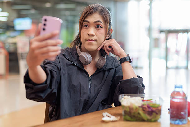 istock Transgender non binary woman taking selfie with mobile phone during lunch break after workout 2230272252
