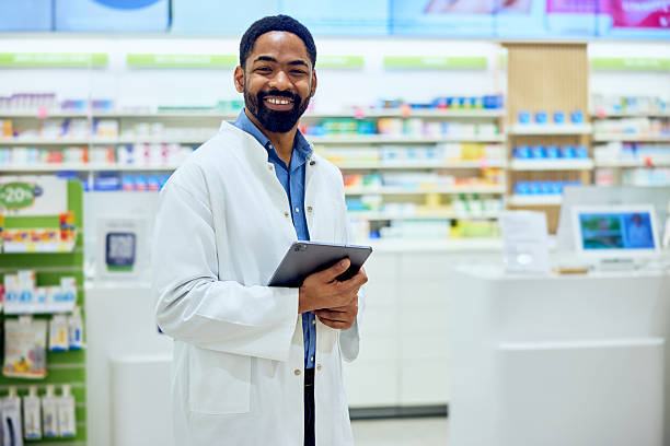 istock Friendly Pharmacist Holding Tablet in Pharmacy for Assistance 2230272324
