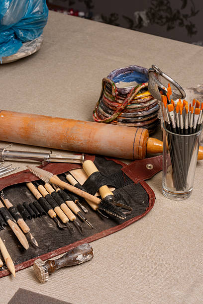istock Pottery Tools, Clay, and Handmade Ceramic Cup in Ceramic Artist Studio 2230272543