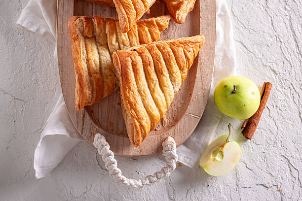 istock Homemade apple triangle cake served in sunny kitchen. 2230272825