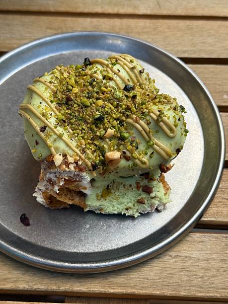 istock Pistachio Dessert with Cream Drizzle on Metal Plate 2230273058