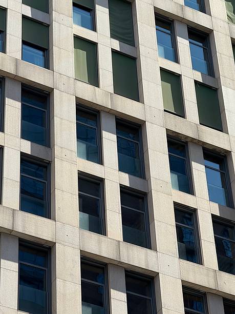 istock Modern Building Facade with Grid Pattern and Green Window Shades 2230273079