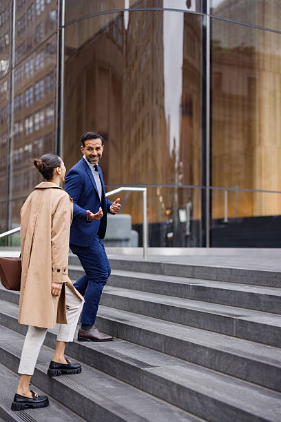 istock Businesspeople walking up stairs and talking 2230273624