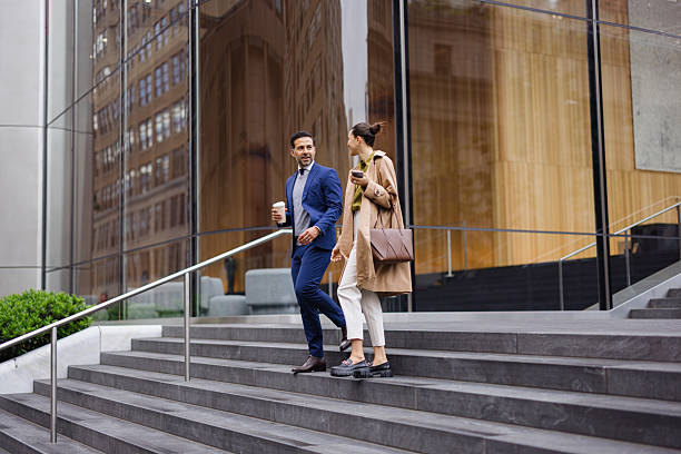 istock Business Professionals Conversing on City Steps 2230273633