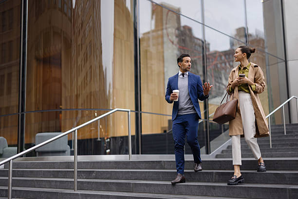 istock Young Professionals Discussing Business on City Steps 2230273649