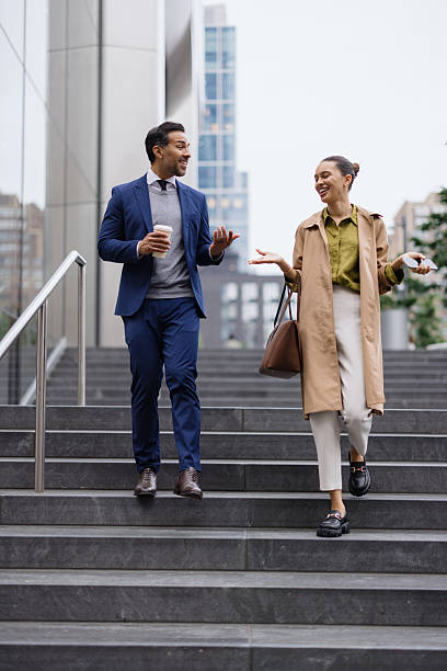 istock Business partners walking down the stairs and talking 2230273670