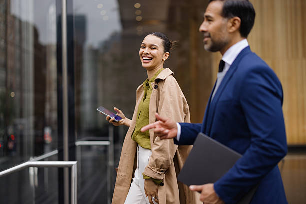 istock Businesspeople walking and talking outside office building 2230273688