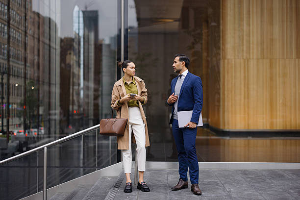 istock Business partners discussing a project in front of modern office building 2230273693