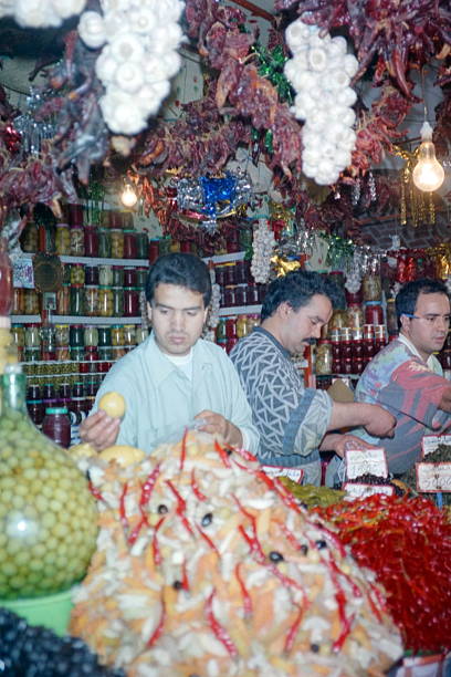 A vibrant display of various olives in a market setting, showcasing a colorful assortment of fresh produce.