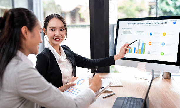 istock Two female business professionals as they work together on a computer in a modern office, conveying a sense of discussion, strategy, and teamwork. 2230275276