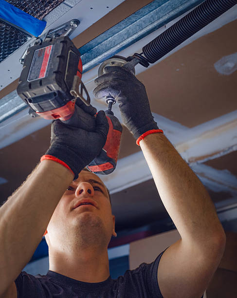 istock Man repairing garage door from inside 2230275567