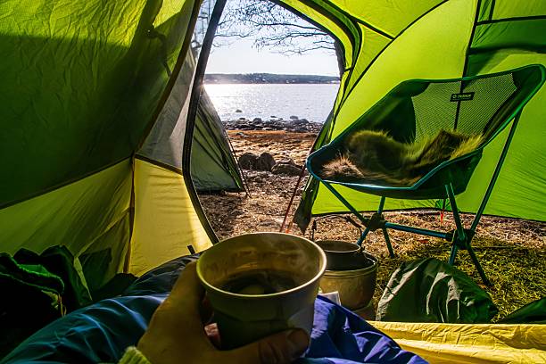 istock Tent view with cup and lakeside landscape. 2230276379
