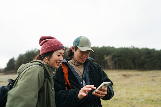 istock Asian couple using mobile phone to plan a hiking route 2230276959