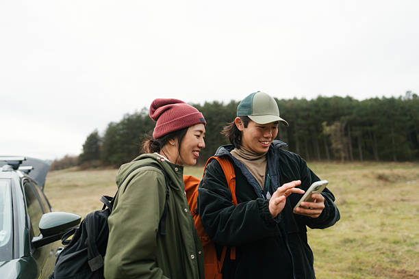 istock Asian couple using mobile phone to plan a hiking route 2230276986