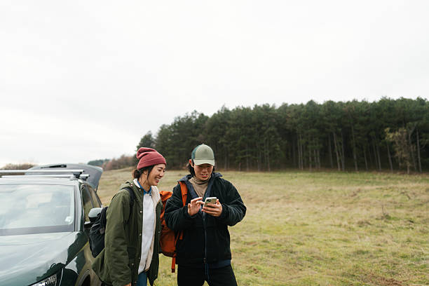 istock Asian couple using mobile phone to plan a hiking route 2230276999