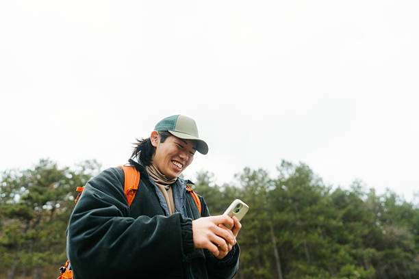 istock Asian man using mobile phone to plan a hiking route 2230277008