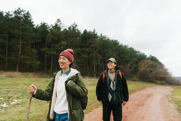 istock Asian couple on a hiking adventure 2230277024