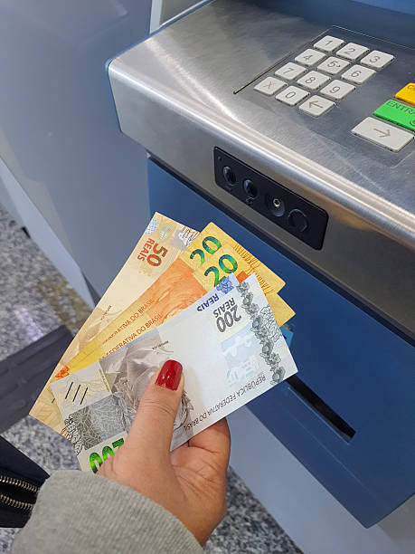 istock Withdrawing money from ATM 2230278023