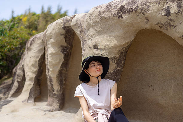 Female tourist resting on rock