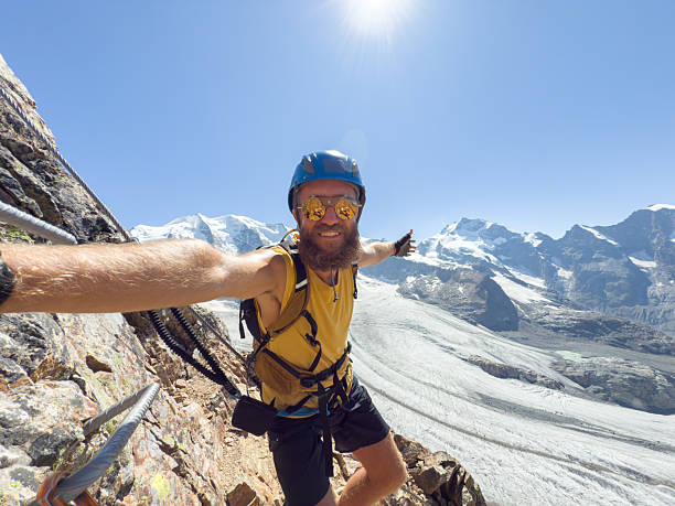 istock Smiling Male Climber Taking Selfie on Mountain 2230279689