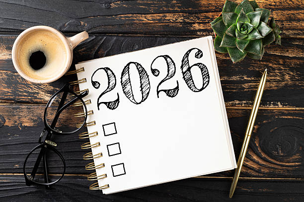 istock New year resolutions 2026 on desk. 2026 resolutions list with notebook, coffee cup on table. Goals, resolutions, plan, action, checklist concept. New Year 2026 template 2230280782