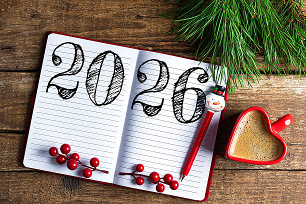 istock New year resolutions 2026 on desk. 2026 resolutions list with notebook, coffee cup on wooden table. Goals, resolutions, plan, action, checklist concept. New Year 2026 template 2230281066