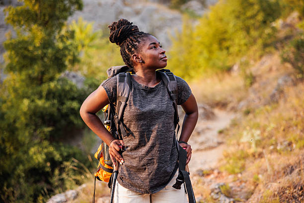 African American female hiker exploring nature and enjoys in the mountains