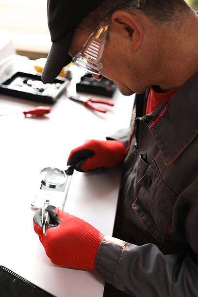 istock Senior Male Technician Surrounded By Tools While Repairing Phones 2230282112