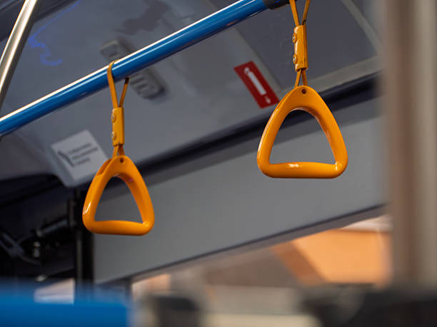 istock Brightly Colored Bus Handholds for Commuters in Urban Transit 2230282292