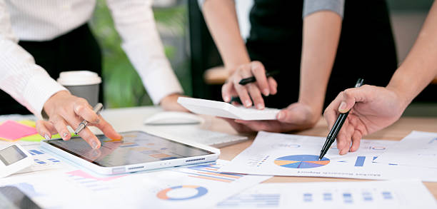 istock Business team discussing charts and data on desk with digital tablet during meeting. 2230282547