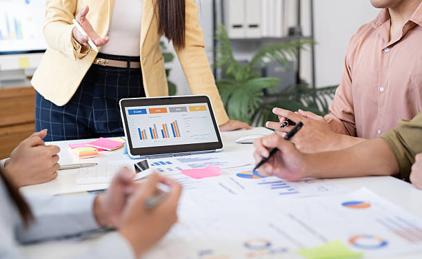 istock Close-up of business team discussing financial data with charts and graphs on a digital tablet during a meeting. 2230282921