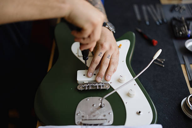 istock Luthier repairing electric guitar in his workshop 2230283179