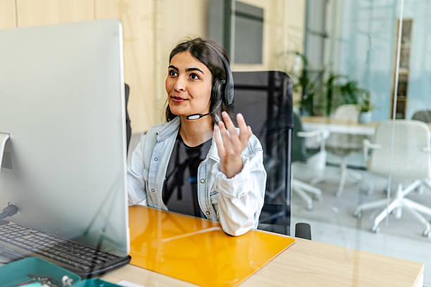 istock Young woman engaged in a video call while working from a bright and modern living space 2230286050