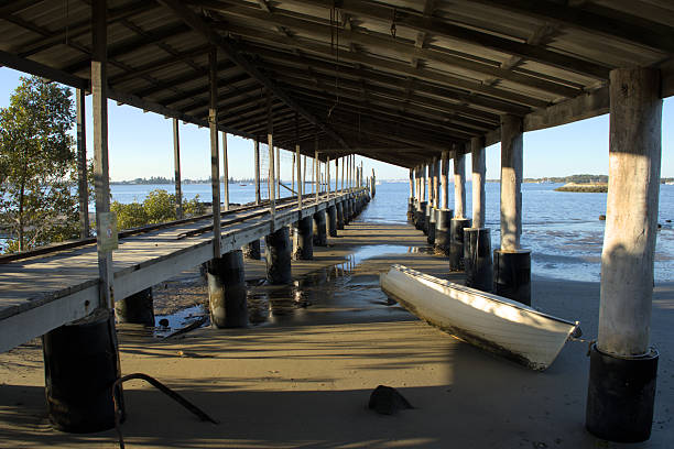 Old jetty and boat on Sydney's Botany Bay looking out toward the bay