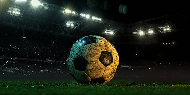 istock Dirty soccer ball on 3D stadium field under night lights 2230288885