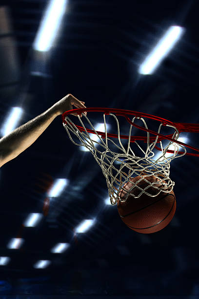 istock Basketball dunk under 3D stadium lights with intense motion 2230288905