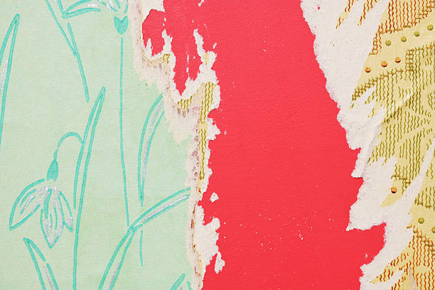 istock Old wallpaper on the wall. Old torn wallpaper for texture or background. 2230293713