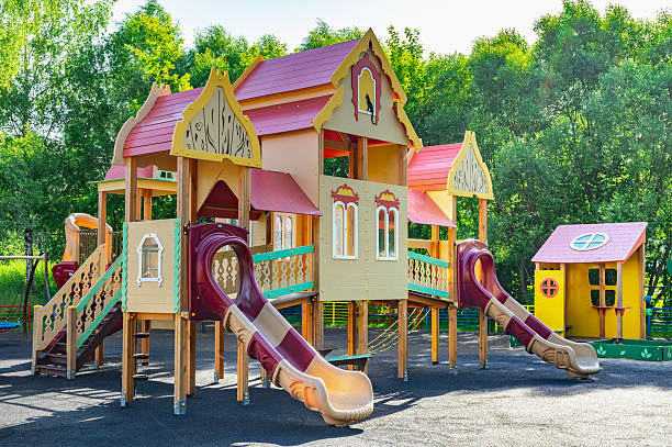 Vibrant children's playground featuring detailed play structures and spiral slides in a lush park setting. The colorful design invites imaginative play and exploration for children.