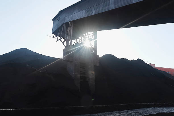 istock Heaps of coal under the roar storage of anthracite. 2230294304