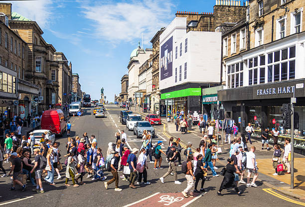 Edinburgh, Scotland - Pedestrians crossing the road at the junction between Hanover Street and Princes Street in central Edinburgh during July.