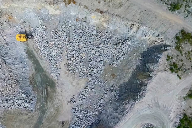 istock Granite quarry, view from above Yellow Excavator 2230297194