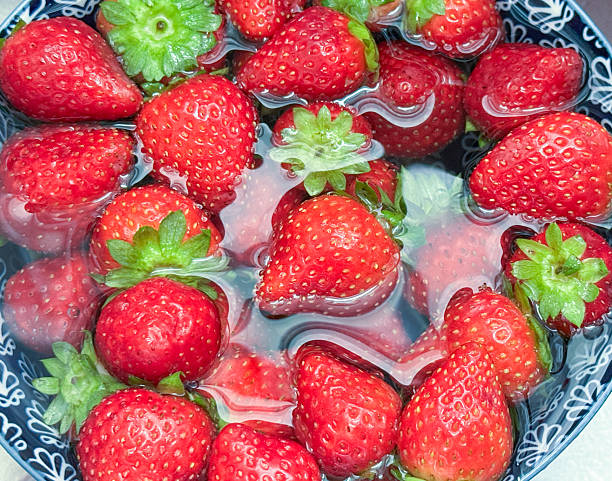 Fresh Being Washed Strawberries In A Bowl