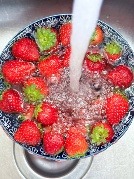 istock Fresh Being Washed Strawberries In A Bowl 2230298335