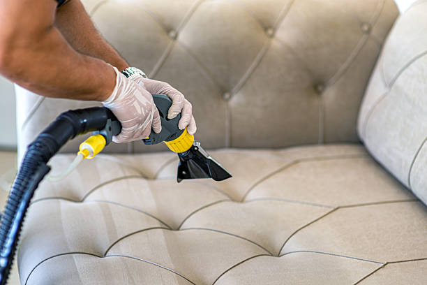 istock Man spraying water with electric sofa washing machine 2230298356