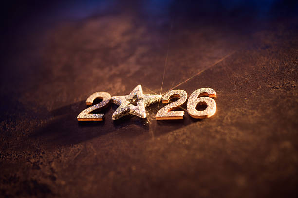 istock Golden glitter star replacing zero in 2026 on dark textured background 2230299202
