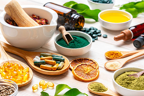 istock White table filled with nutritional supplements and natural vitamins. Healthy eating and wellbeing. Healthcare or alternative medicine. Spirulina and Moringa powder, Omega-3 capsules, Magnesium and Calcium. 2230299320