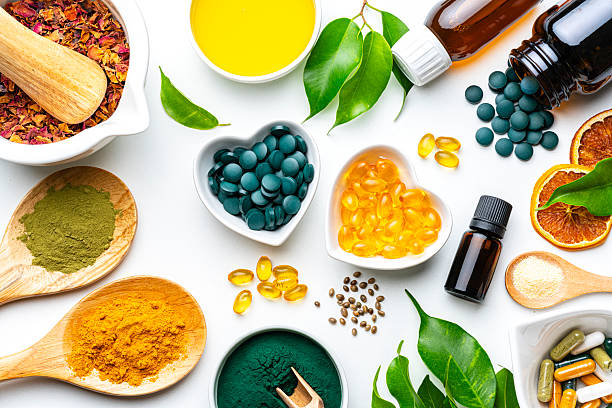 istock Nutritional supplements and natural vitamins or healthy eating and dieting on white background. Healthcare or alternative medicine. Spirulina pills and Omega-3 capsules, Magnesium and Calcium 2230299331